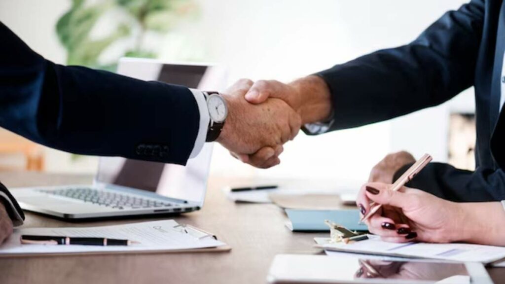 Business professionals shaking hands to finalize a successful agreement